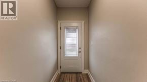 Hamilton apartment for rent - A white door is in the middle of a hallway.