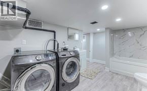 Hamilton apartment for rent - A laundry room with a washer and dryer.