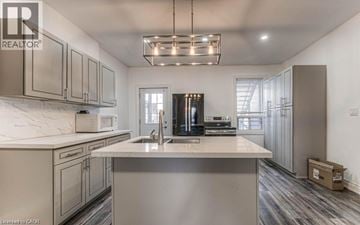Hamilton apartment for rent - A modern kitchen with a large island and stainless steel appliances.