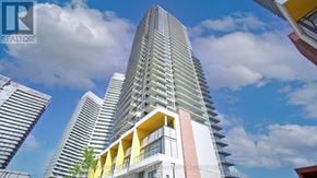 Toronto (Bayview Village) condo for rent - A tall residential building with balconies and a clear sky in the background.