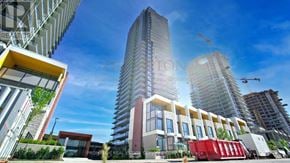 Toronto (Bayview Village) condo for rent - A modern building with a red dumpster in front of it.