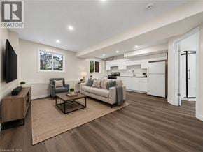 Waterloo apartment for rent - A living room with a grey couch, a coffee table, and a television.