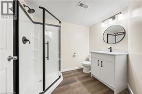 Waterloo apartment for rent - A bathroom with a toilet, sink, and shower.