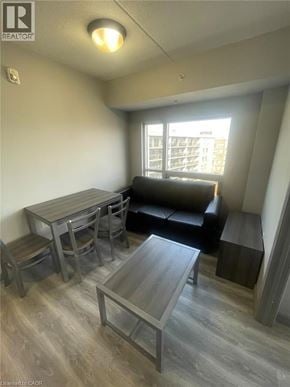 Waterloo condo for rent - A living room with a couch, table, and chairs.