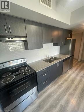 Waterloo condo for rent - A modern kitchen with a stove, sink, and cabinets.