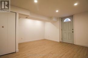 Toronto (South Riverdale) townhouse for rent - A room with a white door and a window with a stained glass design.