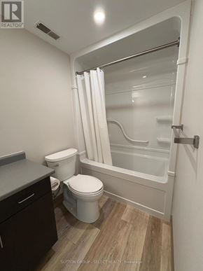 London South (South J) condo for rent - A white toilet sits next to a bathtub in a small bathroom.