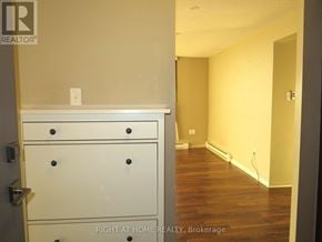 London South (South O) condo for rent - A white dresser with four drawers is in a room with wood flooring and a white wall.