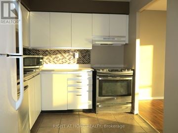 London South (South O) condo for rent - A kitchen with white cabinets and a stainless steel oven.