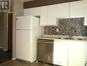 London South (South O) condo for rent - A white refrigerator is in a kitchen with a stainless steel dishwasher.