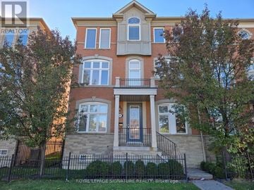 Vaughan (East Woodbridge) townhouse for rent - A two-story brick house with a balcony in front.