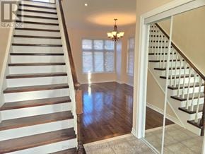 Vaughan (East Woodbridge) townhouse for rent - A staircase with a chandelier in the background.