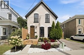 Brantford apartment for rent - A house with a well-maintained garden in front.