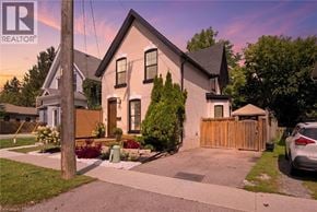 Brantford apartment for rent - A house with a car parked in front of it.