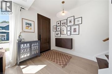 Brantford apartment for rent - A living room with a brown rug and a wooden door.