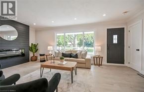 Brantford apartment for rent - A living room with a sofa, armchairs, and a coffee table.