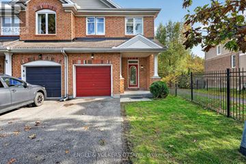 Ottawa townhouse for rent - A house with a red garage door is for sale.