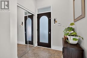 Ottawa townhouse for rent - A plant sits on a wooden table in front of a mirror.