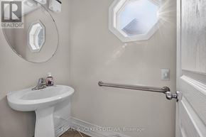 Ottawa townhouse for rent - A white sink in a bathroom with a mirror above it.