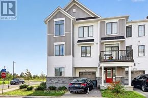 Ottawa townhouse for rent - A modern two-story apartment building with a balcony on the second floor.