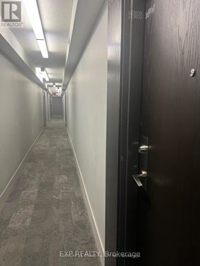 Toronto (Little Portugal) condo for rent - A long hallway with a door on the right.