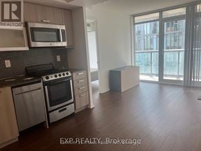 Toronto (Little Portugal) condo for rent - A kitchen with EXP Realty Brokerage watermark.