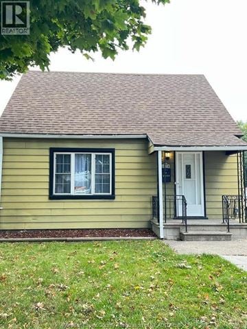 Windsor apartment for rent - A small house with a white door and black railings.