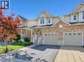 Kitchener apartment for rent - A house with a red tree in front of it.