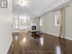 Vaughan (Vellore Village) apartment for rent - A spacious living room with wood flooring and a white ceiling.