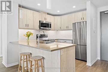 Lincoln (Lincoln-Jordan/Vineland) condo for rent - A modern kitchen with wooden cabinets and stainless steel appliances.