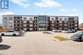Lincoln (Lincoln-Jordan/Vineland) condo for rent - A parking lot with cars and a multi-story building in the background.
