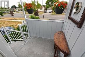 Mississauga (Erin Mills) apartment for rent - A small balcony with a wooden stool and a white railing.