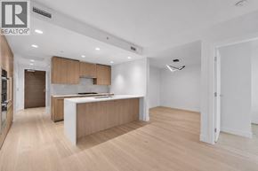 North Vancouver apartment for rent - A modern kitchen with wooden floors and a central island.
