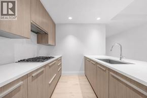 North Vancouver apartment for rent - A modern kitchen with wooden cabinets and a white countertop.