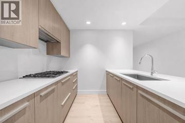 North Vancouver apartment for rent - A modern kitchen with wooden cabinets and a white countertop.