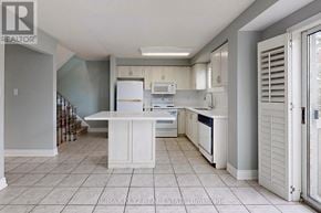 Vaughan (Maple) townhouse for rent - A kitchen with white appliances and cabinets.