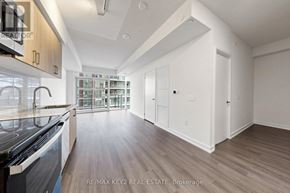 Toronto (Humber Heights) condo for rent - A modern kitchen with wooden floors and white walls.
