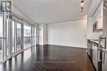 Toronto (Mimico) condo for rent - A spacious kitchen with dark wood floors and stainless steel appliances.