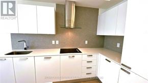 Toronto (Lansing-Westgate) condo for rent - A kitchen with white cabinets and a sink.