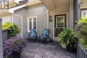 Huntsville townhouse for rent - A small porch with a chair and a table.