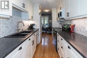 Huntsville townhouse for rent - A kitchen with white cabinets and black countertops.