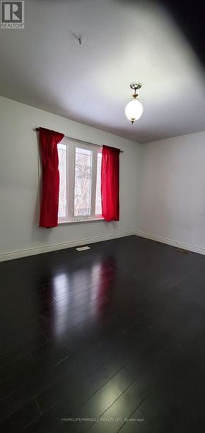 Pickering (Rosebank) apartment for rent - A room with a window and red curtains.