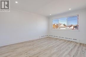 Ottawa condo for rent - A room with a window showing a view of houses outside.