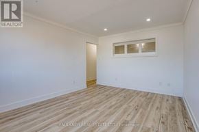 Ottawa condo for rent - A room with wooden flooring and a window with blinds.