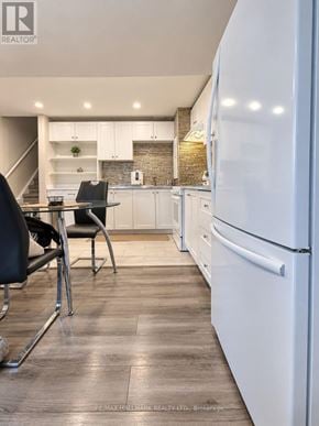 Milton (Wi Willmott) apartment for rent - A modern kitchen with a white fridge, black chairs and wooden floors.