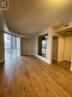 Toronto (Waterfront Communities) condo for rent - A room with wooden flooring and a window with blinds.
