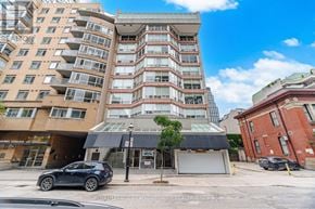 Toronto (Church-Yonge Corridor) condo for rent - A multi-story residential building with a car parked in front.