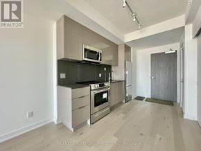 Toronto (Church-Yonge Corridor) condo for rent - A modern kitchen with stainless steel appliances and a microwave above the stove.