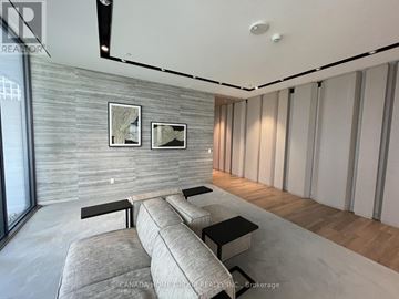 Toronto (Church-Yonge Corridor) condo for rent - A modern living room with a grey sofa and a wooden floor.