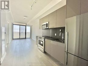Toronto (Church-Yonge Corridor) condo for rent - A modern kitchen with stainless steel appliances and a large window.